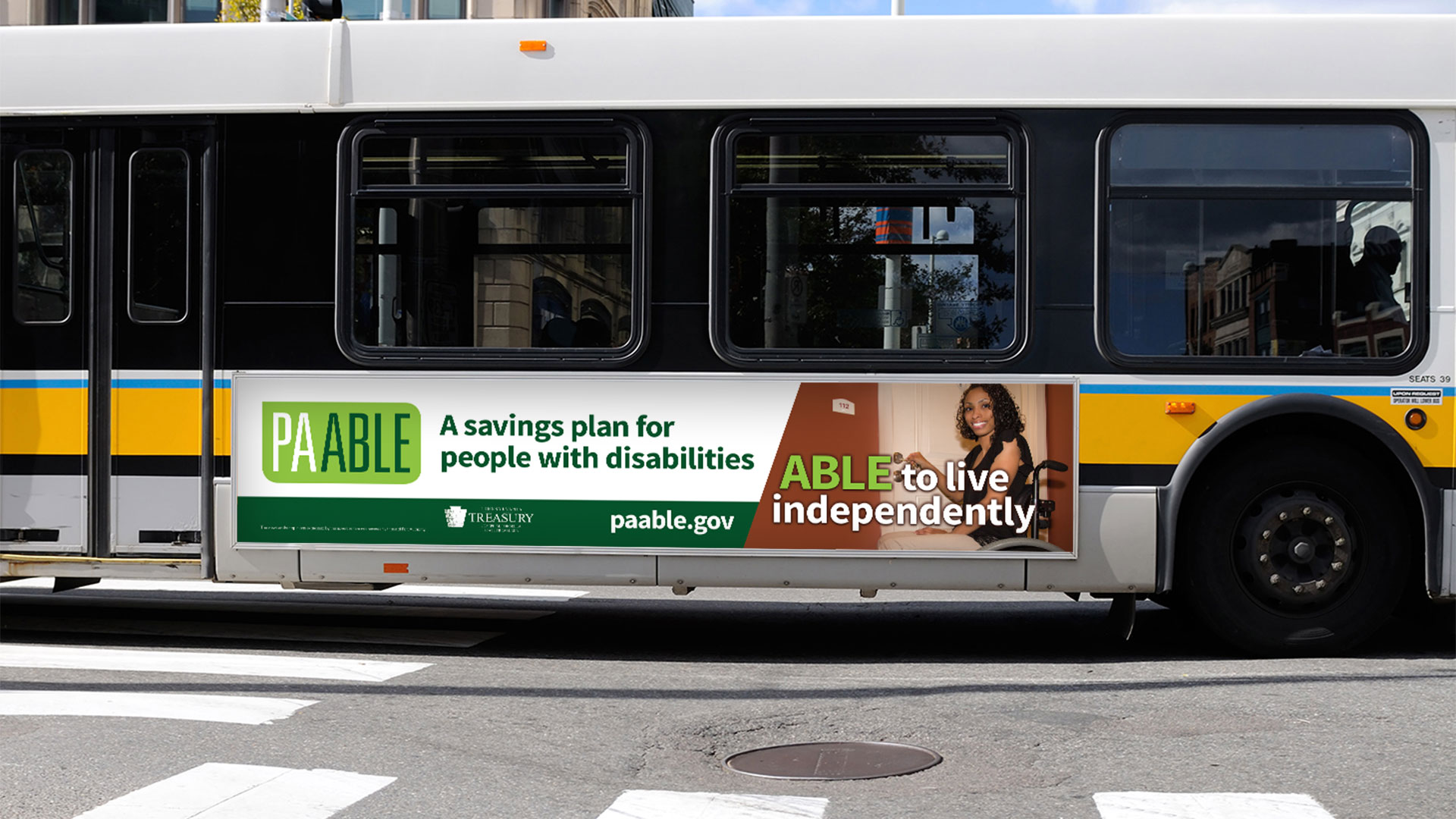 An advertisement on the side of a bus depicting PA ABLE campaign graphics